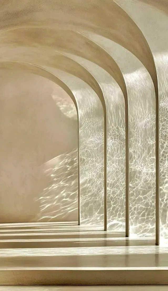 Arched corridor with water-light reflections dancing across warm plaster walls