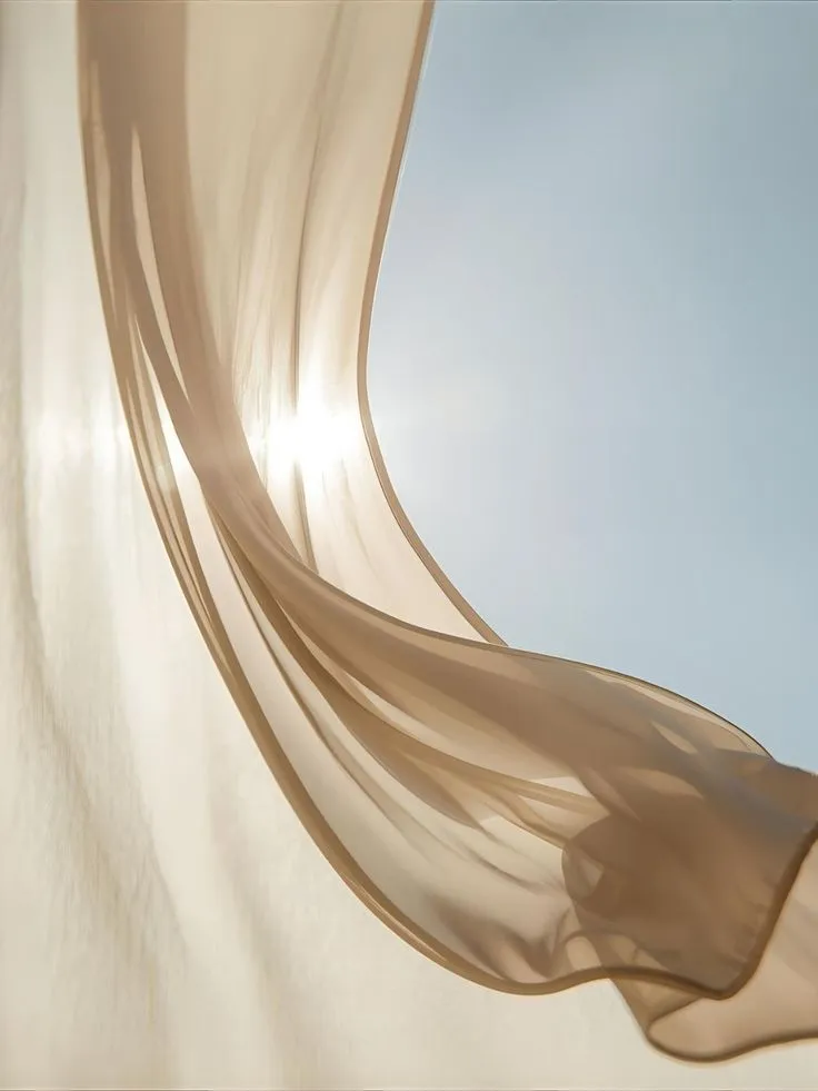 Sheer fabric billowing in a circle against bright sunlight