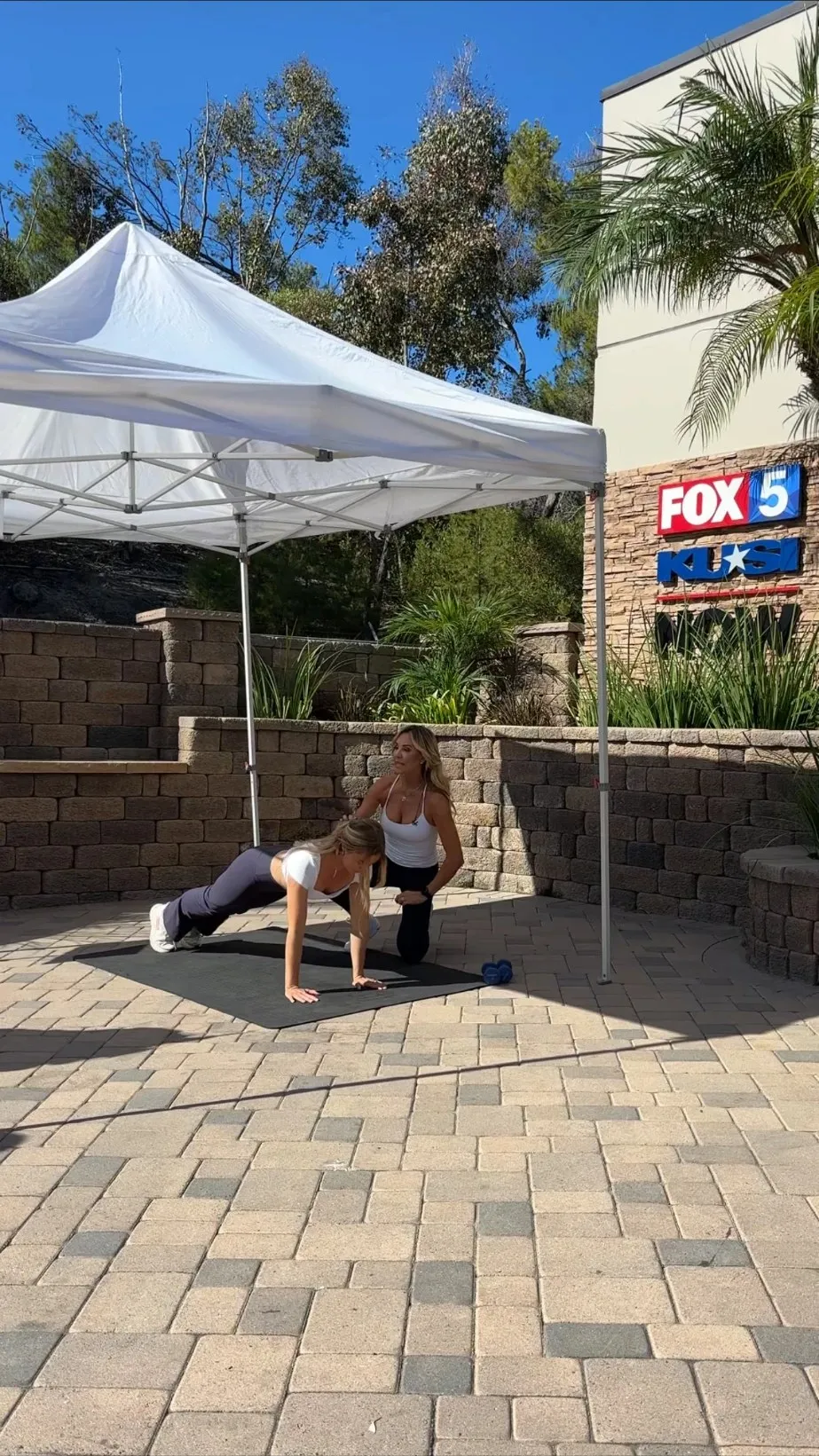 Charlotte coaching a client in a plank hold outdoors at Fox 5 / KUSI San Diego